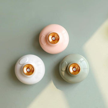 Minimalist stylish floating humidifier in pink, green, and white