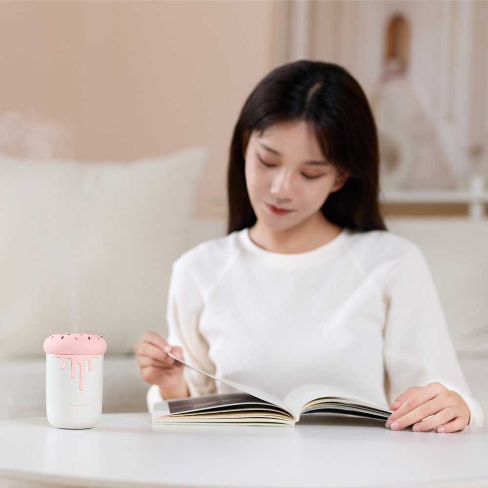 Woman reading beside donut humidifier