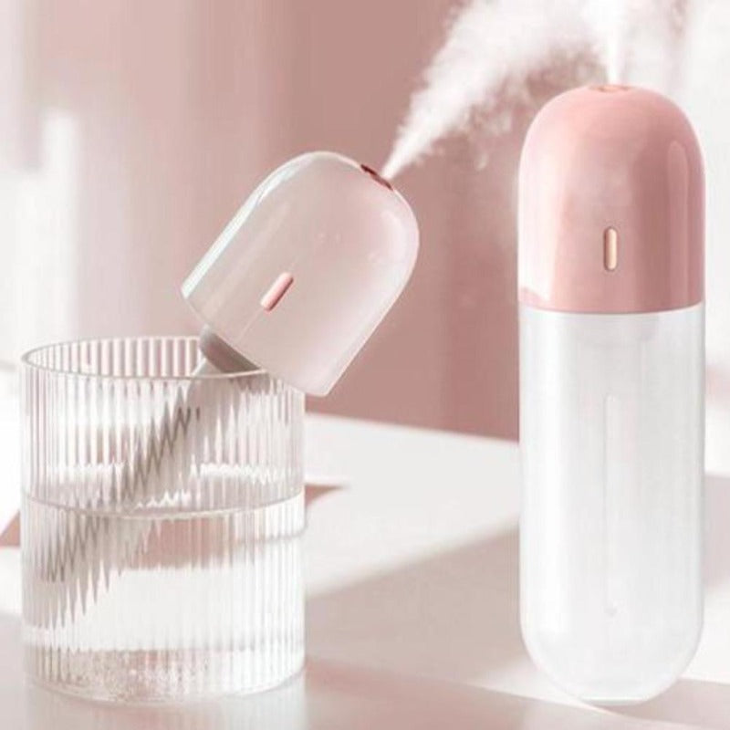 Portable mini humidifier in a cup of water