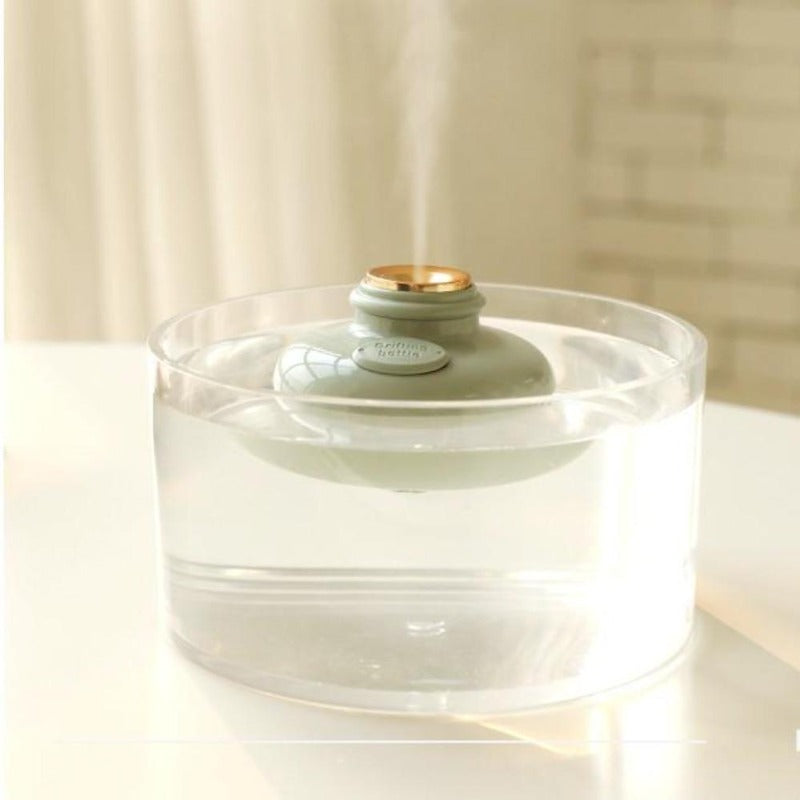 Minimalist stylish humidifier in green floating in glass of water