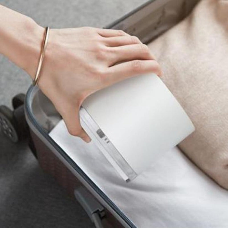 White minimalist humidifier lamp being put in suitcase