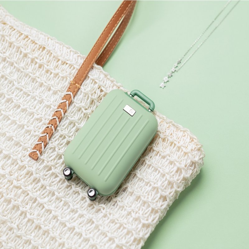 Cute traveler power bank in mint green with hand warmer, shaped like a suitcase